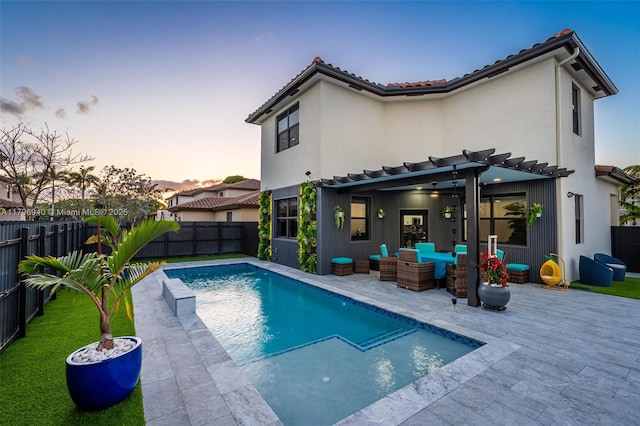 rear view of property with an outdoor living space, a fenced in pool, a patio area, a pergola, and a fenced backyard