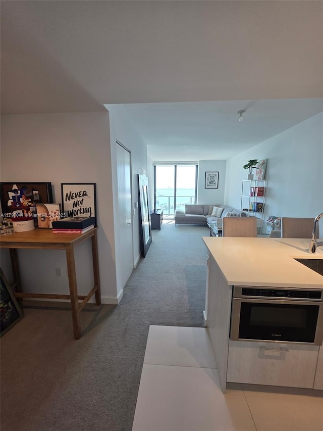 501 NE 31st St Unit 2802, Miami, FL 33137 - kitchen featuring light carpet, stainless steel oven, and light countertops