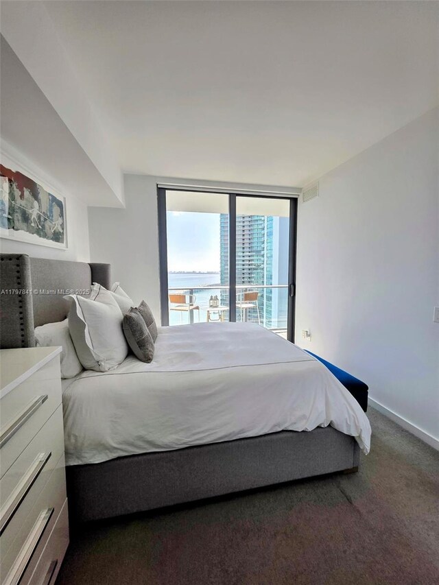 501 NE 31st St Unit 2802, Miami, FL 33137 - bedroom with carpet floors, a wall of windows, and access to exterior