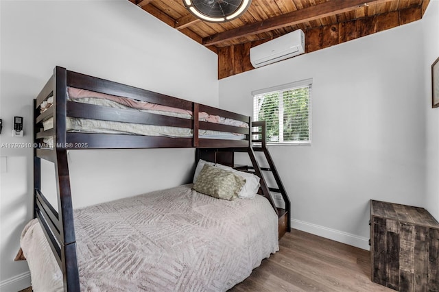 bedroom with a wall mounted AC, baseboards, wood ceiling, wood finished floors, and beamed ceiling