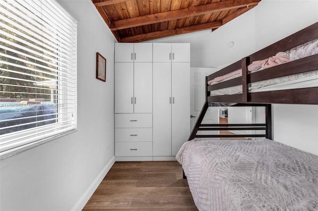 bedroom with wood ceiling, baseboards, wood finished floors, and lofted ceiling with beams