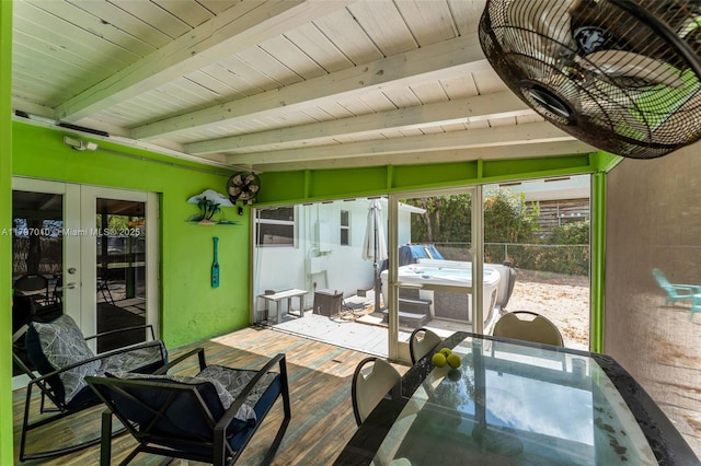 sunroom / solarium featuring french doors, a hot tub, beam ceiling, and outdoor dining area