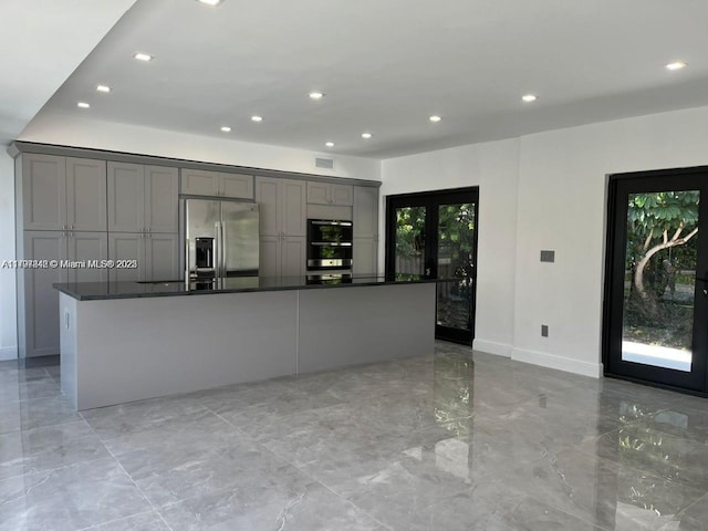 241 186th St, Sunny Isles Beach, FL 33160 - kitchen with stainless steel appliances, gray cabinetry, light marble finish floors, recessed lighting, and dark countertops