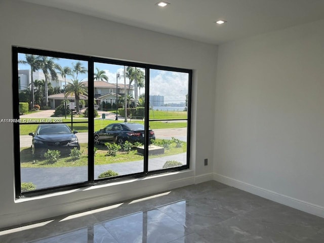 241 186th St, Sunny Isles Beach, FL 33160 - empty room with marble tiled floors, recessed lighting, and baseboards