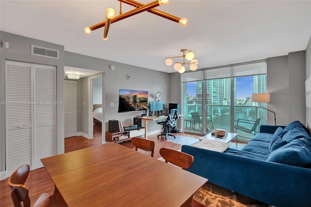 31 SE 5th St Unit 1505, Miami, FL 33131 - living room featuring a chandelier, baseboards, visible vents, and wood finished floors