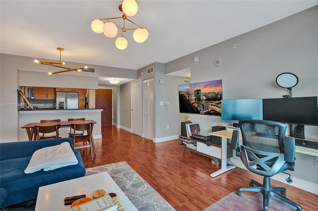 31 SE 5th St Unit 1505, Miami, FL 33131 - living room featuring baseboards, an inviting chandelier, visible vents, and wood finished floors