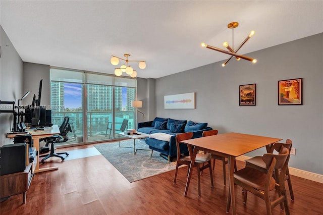 31 SE 5th St Unit 1505, Miami, FL 33131 - dining area featuring an inviting chandelier, a wall of windows, baseboards, and wood finished floors