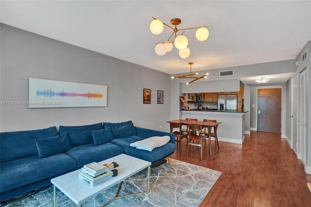 31 SE 5th St Unit 1505, Miami, FL 33131 - living room featuring a chandelier, visible vents, and wood finished floors
