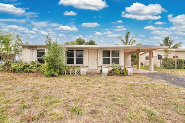 3460 NW 17th St, Lauderhill, FL 33311 - single story home featuring a front lawn, driveway, fence, and an attached carport