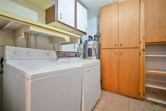 3460 NW 17th St, Lauderhill, FL 33311 - laundry area featuring washing machine and clothes dryer, electric water heater, cabinet space, and light tile patterned floors