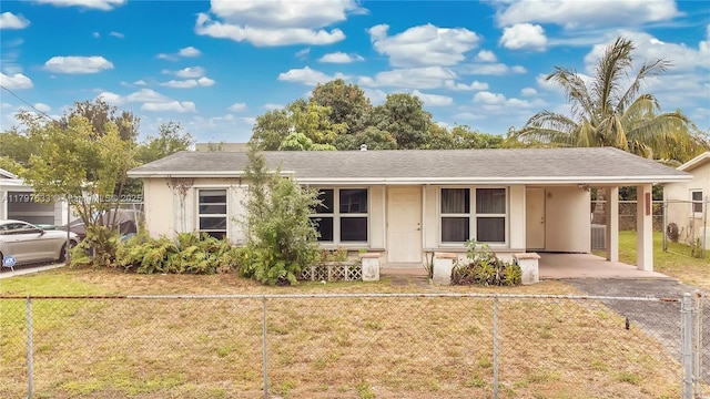 3460 NW 17th St, Lauderhill, FL 33311 - ranch-style house featuring a carport, aphalt driveway, a front lawn, a fenced front yard, and a porch