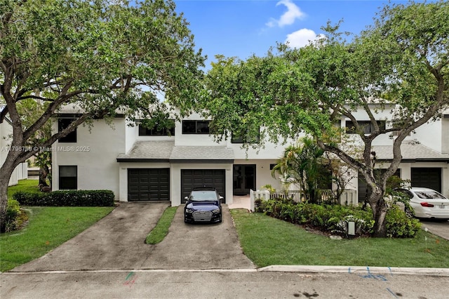 view of front of property featuring a front yard, a garage, stucco siding, and driveway