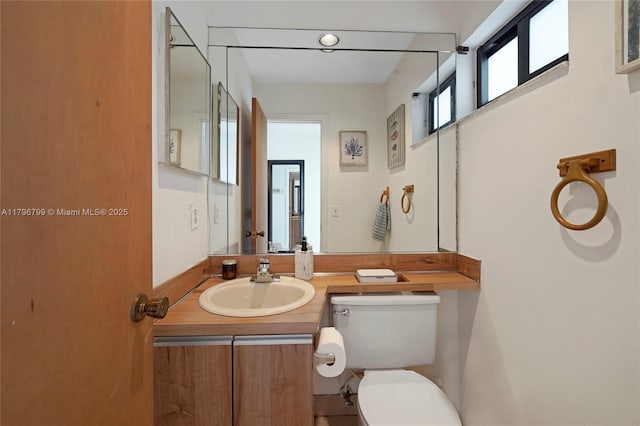bathroom featuring toilet and vanity