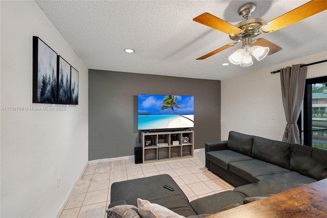 living area with a textured ceiling, tile patterned flooring, baseboards, ceiling fan, and recessed lighting