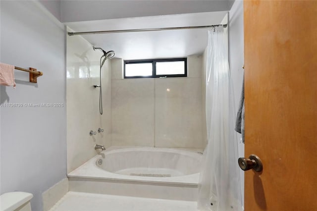 bathroom with toilet and shower / bath combo with shower curtain