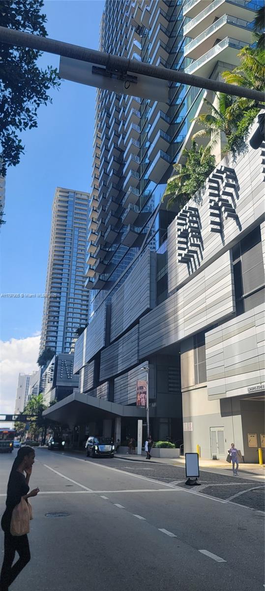 view of building exterior featuring uncovered parking