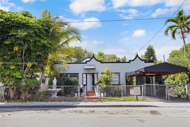 34 NW 34th Ter, Miami, FL 33127 - view of front of house featuring a gate and stucco siding