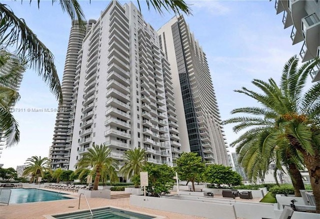 view of building exterior featuring a community pool