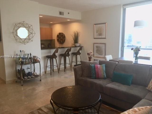 living room featuring plenty of natural light and baseboards