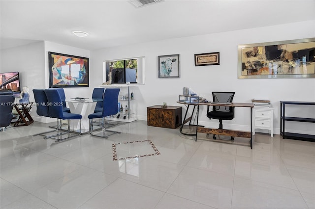 tiled home office with visible vents and baseboards