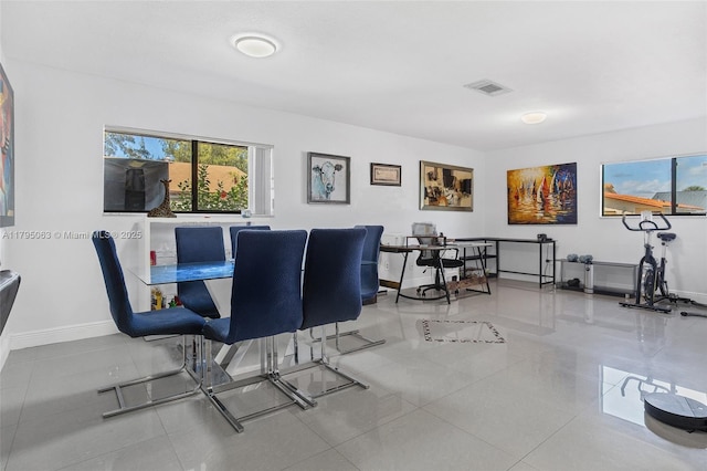 dining area with tile patterned floors, visible vents, and baseboards