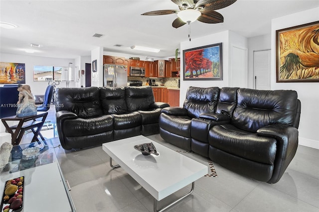 living room featuring a ceiling fan and visible vents