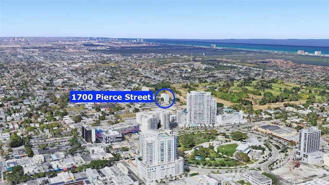 birds eye view of property featuring a water view and a view of city