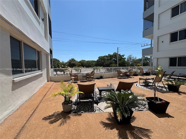 view of patio with outdoor dining area and fence