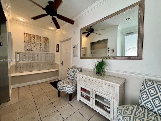 sitting room featuring a textured ceiling, ornamental molding, ceiling fan, tile patterned floors, and mail area