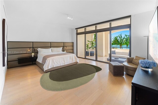 7025 Fisher Island Dr Unit 7025, Miami Beach, FL 33109 - bedroom featuring access to outside, wood finished floors, and expansive windows