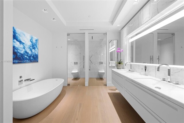 7025 Fisher Island Dr Unit 7025, Miami Beach, FL 33109 - full bath with toilet, double vanity, a freestanding bath, a marble finish shower, and a tray ceiling