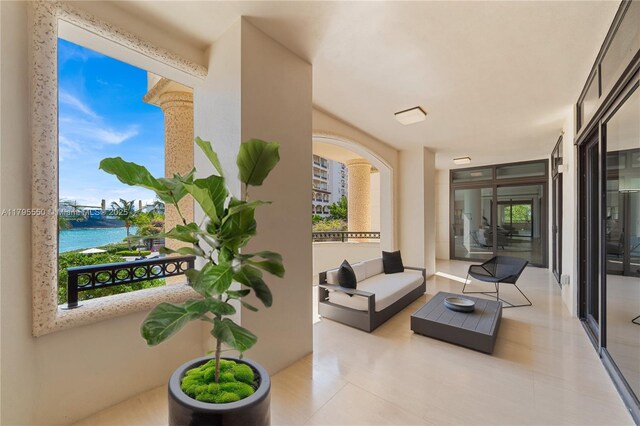 7025 Fisher Island Dr Unit 7025, Miami Beach, FL 33109 - view of patio / terrace featuring a balcony, a water view, and an outdoor hangout area