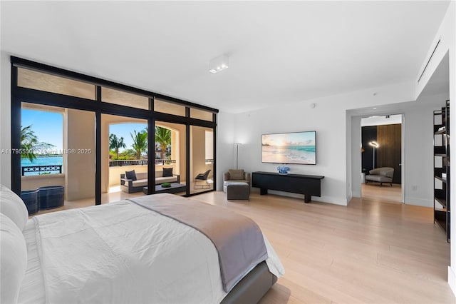 7025 Fisher Island Dr Unit 7025, Miami Beach, FL 33109 - bedroom featuring access to outside, light wood-style floors, floor to ceiling windows, and baseboards
