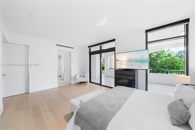 7025 Fisher Island Dr Unit 7025, Miami Beach, FL 33109 - bedroom with access to outside and light wood-style floors