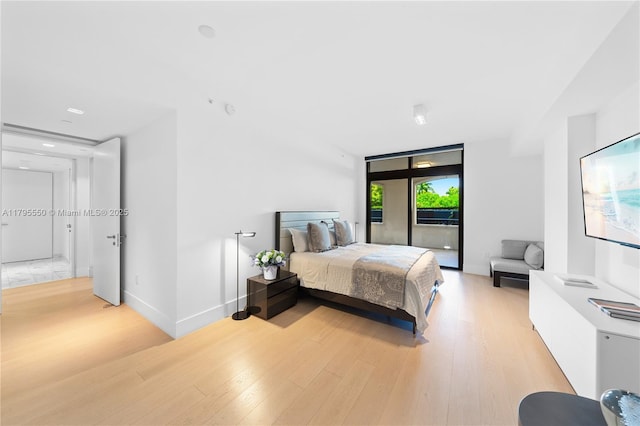 7025 Fisher Island Dr Unit 7025, Miami Beach, FL 33109 - bedroom with access to exterior, light wood finished floors, and baseboards