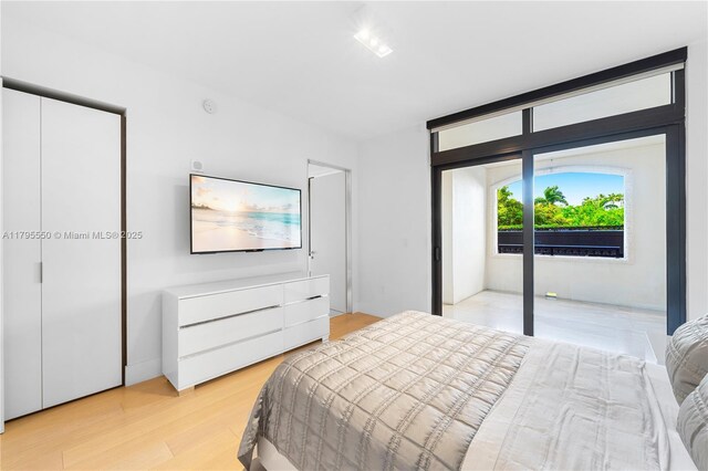 7025 Fisher Island Dr Unit 7025, Miami Beach, FL 33109 - bedroom featuring light wood-style flooring and access to outside