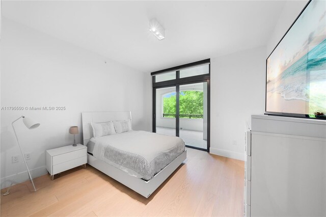 7025 Fisher Island Dr Unit 7025, Miami Beach, FL 33109 - bedroom with access to outside, light wood finished floors, and baseboards