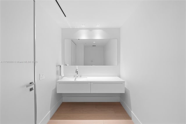 7025 Fisher Island Dr Unit 7025, Miami Beach, FL 33109 - bathroom featuring wood finished floors, vanity, and baseboards