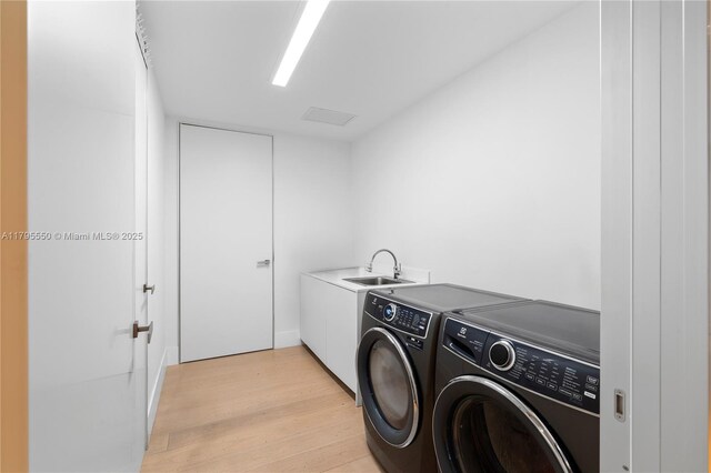 7025 Fisher Island Dr Unit 7025, Miami Beach, FL 33109 - laundry area with separate washer and dryer, cabinet space, and light wood-style floors