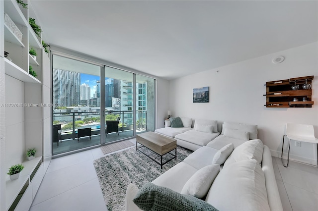 tiled living room featuring a wall of windows and a view of city