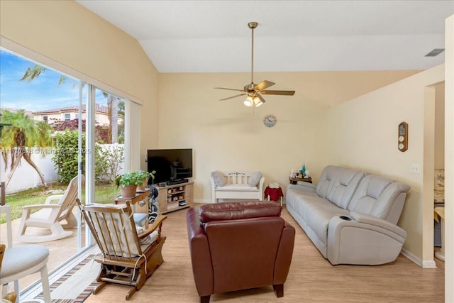 living area featuring light wood-style flooring, visible vents, baseboards, ceiling fan, and lofted ceiling