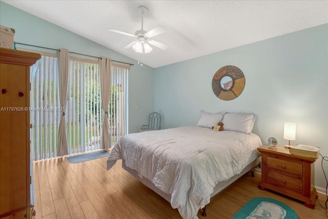 bedroom featuring wood finished floors, a textured ceiling, ceiling fan, access to outside, and lofted ceiling