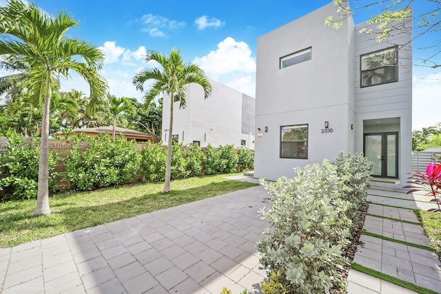 2330 SW 14th St, Miami, FL 33145 - view of front of house featuring a front lawn, stucco siding, and a patio