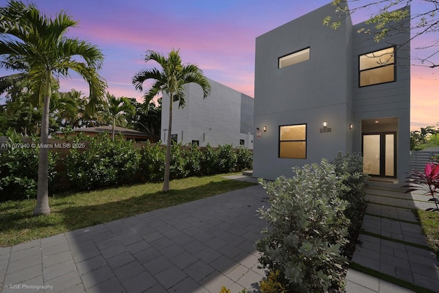 2330 SW 14th St, Miami, FL 33145 - view of front facade with stucco siding, a yard, and a patio