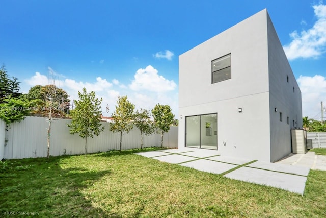 2330 SW 14th St, Miami, FL 33145 - rear view of property featuring a fenced backyard, a patio area, stucco siding, and a yard