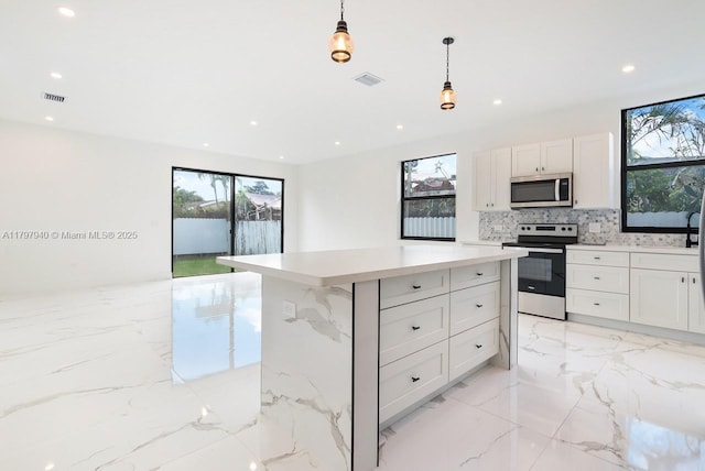 2330 SW 14th St, Miami, FL 33145 - kitchen with appliances with stainless steel finishes, visible vents, marble finish floor, and a healthy amount of sunlight