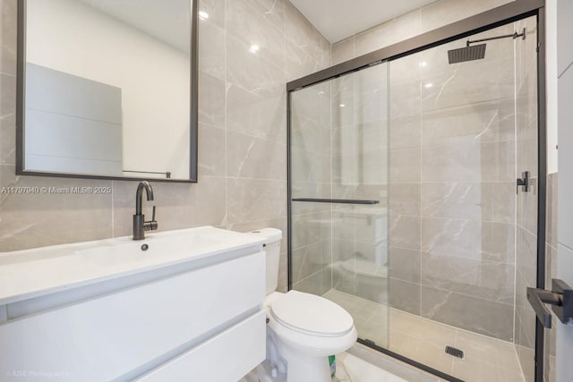 2330 SW 14th St, Miami, FL 33145 - full bathroom featuring a shower stall, tile walls, vanity, and toilet
