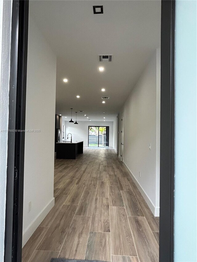1611 SW 30th Ave, Fort Lauderdale, FL 33312 - hallway featuring a sink, wood finished floors, visible vents, recessed lighting, and baseboards