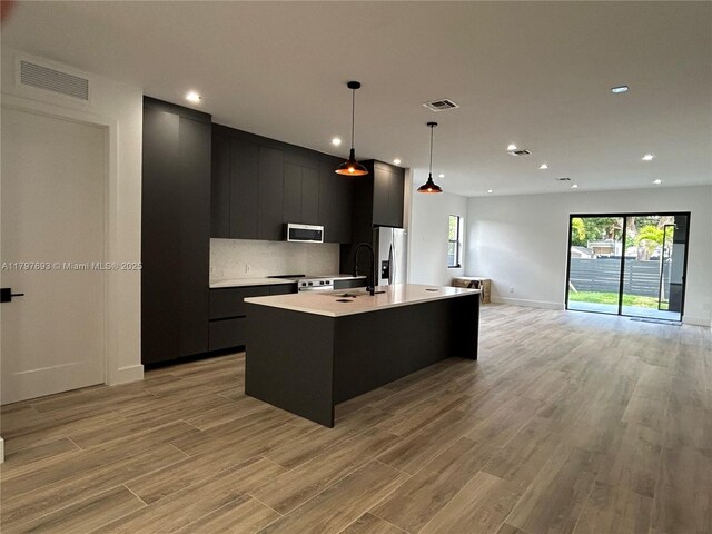 1611 SW 30th Ave, Fort Lauderdale, FL 33312 - kitchen with stainless steel appliances, dark cabinetry, light countertops, and visible vents
