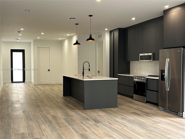 1611 SW 30th Ave, Fort Lauderdale, FL 33312 - kitchen featuring appliances with stainless steel finishes, a sink, modern cabinets, light countertops, and dark cabinetry